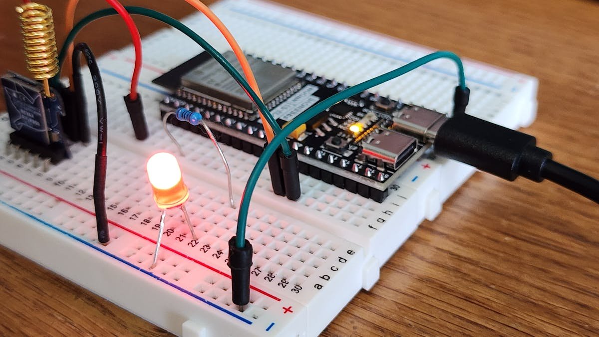 Breadboard prototype with colored jumper wires showing typical hardware debugging setup that Velxio replaces